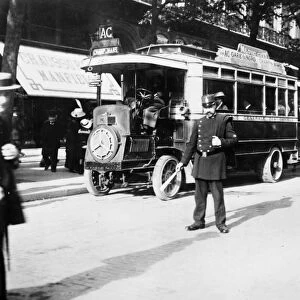 PARIS: OMNIBUS, c1920. A policeman directs traffic on a Parisian boulevard. Photograph