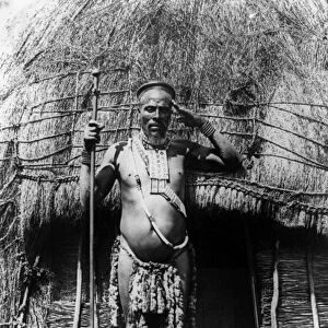 SOUTH AFRICA: ZULU CHIEF. Zulu chief standing in front of a hut in South Africa