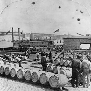 ST. LOUIS: LEVEE, c1898. Unloading barrels of sugar from steamers at the St. Louis Levee