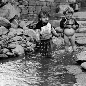 SYRIA: DRUZE CHILDREN, 1938. Druze babies playing in water in Qanawat, Syria. Photograph