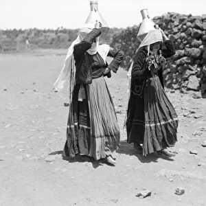 SYRIA: DRUZE WOMEN, 1938. Druze women carrying water in the region of Jabal al-Druze, Syria