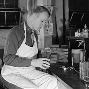 U. S. ARMY LABORATORY, 1943. U. S. Army Captain examining the contents of a K ration