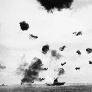 The USS Yorktown under aerial and submarine attack during the Battle of Midway during World War II, 3-6 June 1942; the ship was later sunk by a submarine torpedo