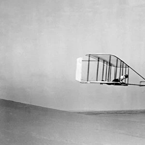 Wilbur Wright flying their glider, near the bottom of Big Hill, Kitty Hawk, North Carolina. Photographed by Orville Wright, 10 October 1902