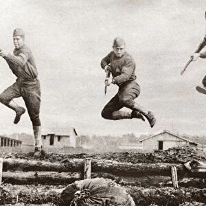 WORLD WAR I: CAMP UPTON. American troops leaping over a trench border during a