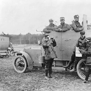WWI: ARMORED CAR, c1915. Soldiers looking at a map by an armored car, possibly in France
