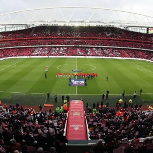 Arsenal and Manchester United shakes hands as the fans hold up Lace Up Save Lives cards