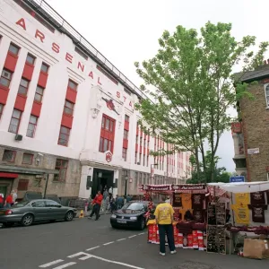 Arsenal Stadium with a house on Conewood Street with Arsenal posters in the windows