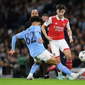 Arsenal's Kieran Tierney Faces Pressure from Manchester City's Rico Lewis in FA Cup Clash