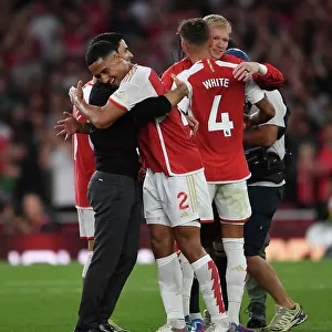 Arsenal's Victory: Mikel Arteta Embraces William Saliba after Beating Manchester City (2023-24)