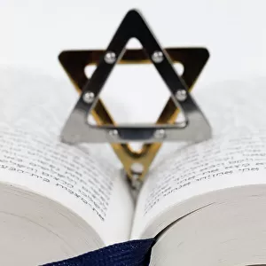Close-up detail of a Torah in hebrew and a star of David. Jewish symbols