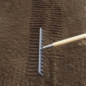 Covering up trench using a rake