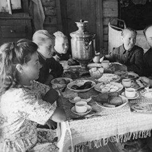 A family at breakfast on the pobeda collective farm, august 1948