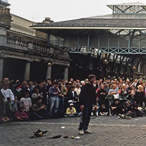 Great Britain, England, London, Covent Garden, Covent Garden Market, crowd watching street performer on monocycle