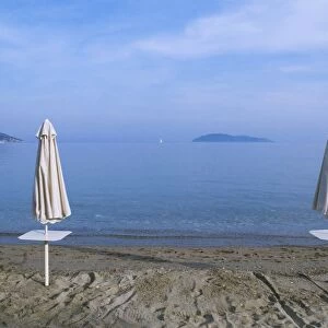 Greece, Sporades, Skiathos island, closed beach umbrellas on Megali Ammos beach