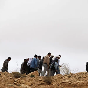 Group of Tunisian muslims walking up a hill