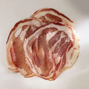 Pancetta, slices of cured pork belly