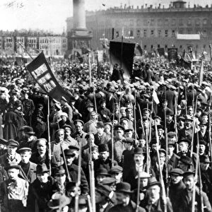 A rally of thousands of russian soldiers and civilians in front of the winter palace in petrograd ( st, petersburg ), protected by the red guard who are shown in the foreground, they were composed of civilians who siezed guns wherever they could be found and rushed to the support of the bolsheviks