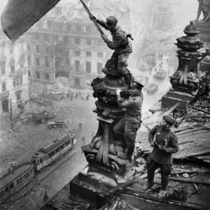 Red army soldiers raising the soviet flag over the reichstag in berlin, germany, april 30, 1945