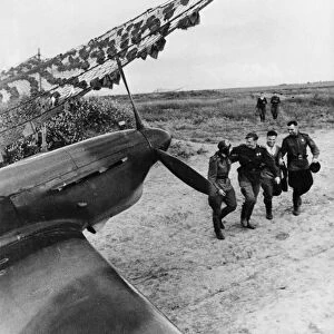 Soviet pilots greeting each other after a mission, yakovlev yak fighter of the soviet air force is in the foreground