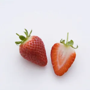 One strawberry and half strawberry, close-up