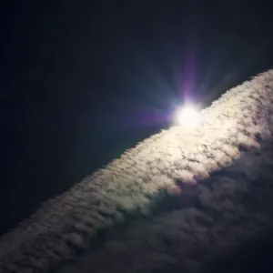 Sun and vapour trails in a dramatic sky, Oxford England j