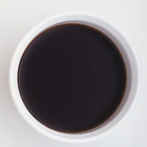 Above view of soy sauce in circular white dish