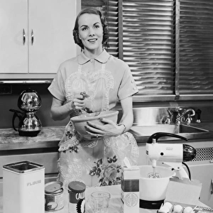 Woman with apron baking in her kitchen