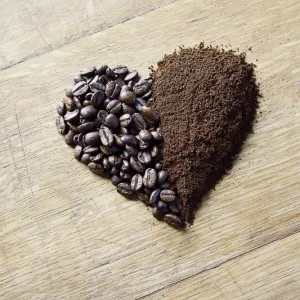 Coffee beans and grounds forming a heart shape