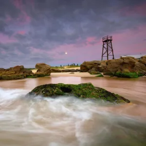 Moon set at sunrise seascape