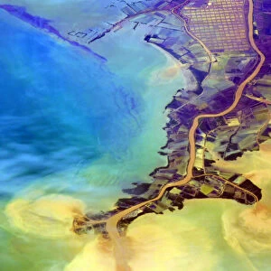 Aerial of flooding river discharging eroded soil, silt and other sediments into the Java Sea
