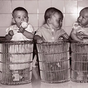 Four babies (6-9 months) in baskets (B&W sepia tone)