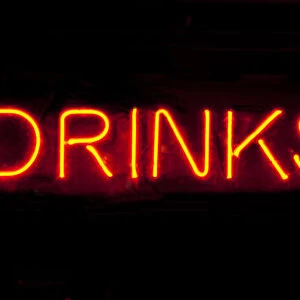 Drinks to go neon sign on a black background