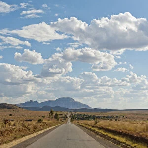 Long straight road, vast arid landscape, sky with clouds, Isalo National Park near Ranohira, Madagascar