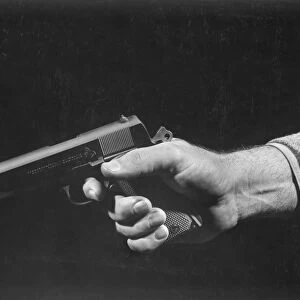 Man holding gun, close up of hand