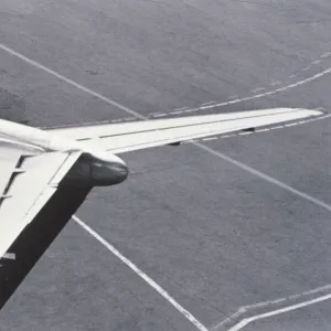 Man standing on tail of plane