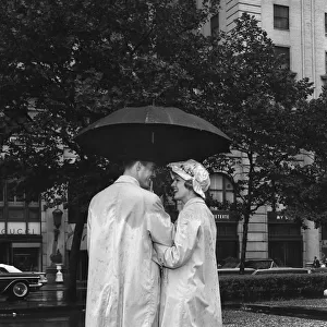 Man and woman under umbrella, color enhanced
