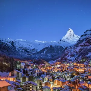 The Matterhorn mountain peak over Zermatt city at night, Switzerland