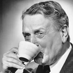 Mature man drinking cup of coffee