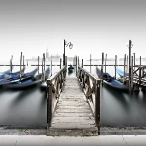 Minimalist long exposure of the gondolas at the Piazzetta near the Campanile at St. Mark's Square in Venice, Italy