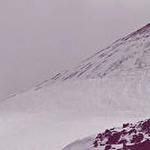 Panoramic view, Mount Etna between clouds and snow