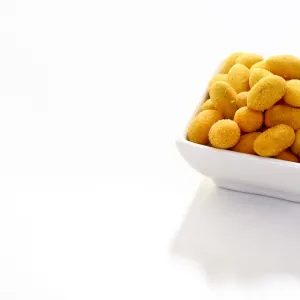 Peanuts in a paprika flavoured coating, in a bowl