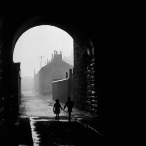 Print of two children walking under an arch in the Gorbals area of Glasgow Print of two children walking under an arch in the Gorbals area of Glasgow