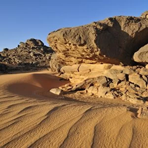 Sandstone rock formation and sand dunes, Adrar Tekemberet, Immidir, Algeria, Sahara, North Africa