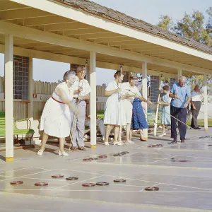 Senior people playing shuffleboard