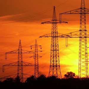 Transmission lines, overhead line towers, with setting sun, Beinstein in Stuttgart, Baden-Wuerttemberg, Germany, Europe