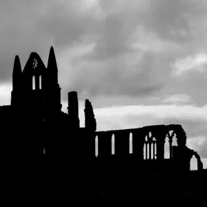 Whitby Abbey silhouetted against a cloudy sky, North Yorkshire, England