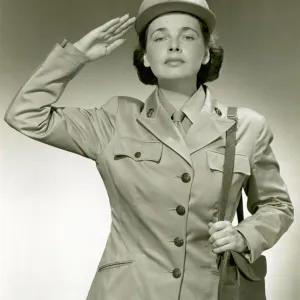 Woman in uniform saluting