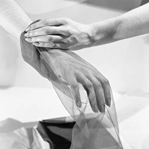 Womans hand inside silk stocking