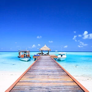 Wooden pier with boats, indian ocean, Maldives